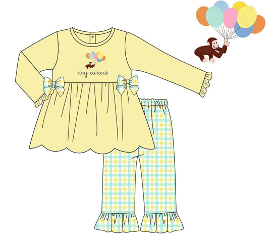 A children's two-piece set shown as a flat illustration on a white background. The set includes a pale yellow long-sleeve top with bow details and a scalloped hem, paired with light blue and yellow plaid pants with ruffled hems.
