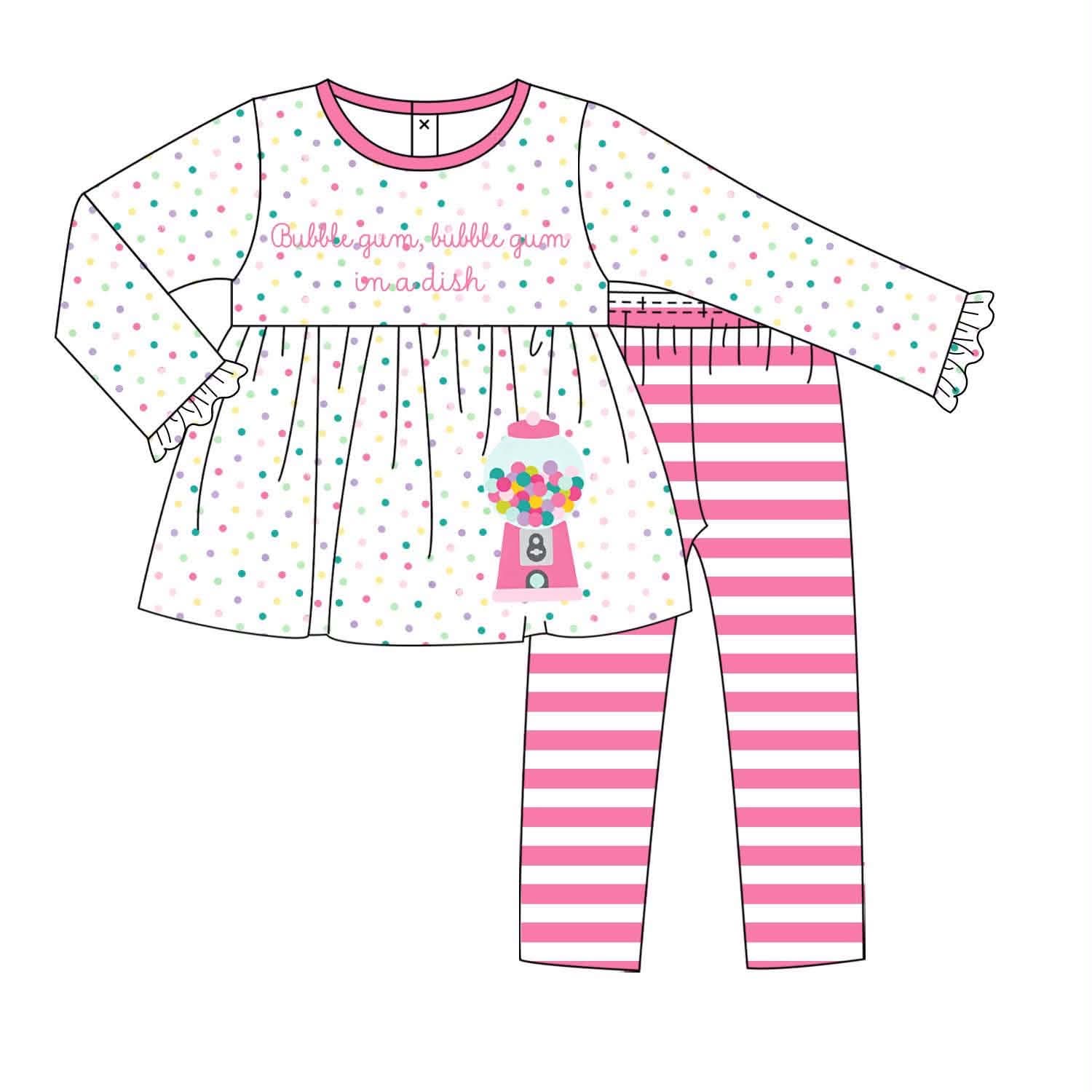 A children's two-piece outfit set shown as a flat illustration on a white background. The top is a long-sleeve white dress with pink trim, scattered pastel polka dots, and a pink gumball machine graphic with the words 'Bubble gum bubble gum madish.